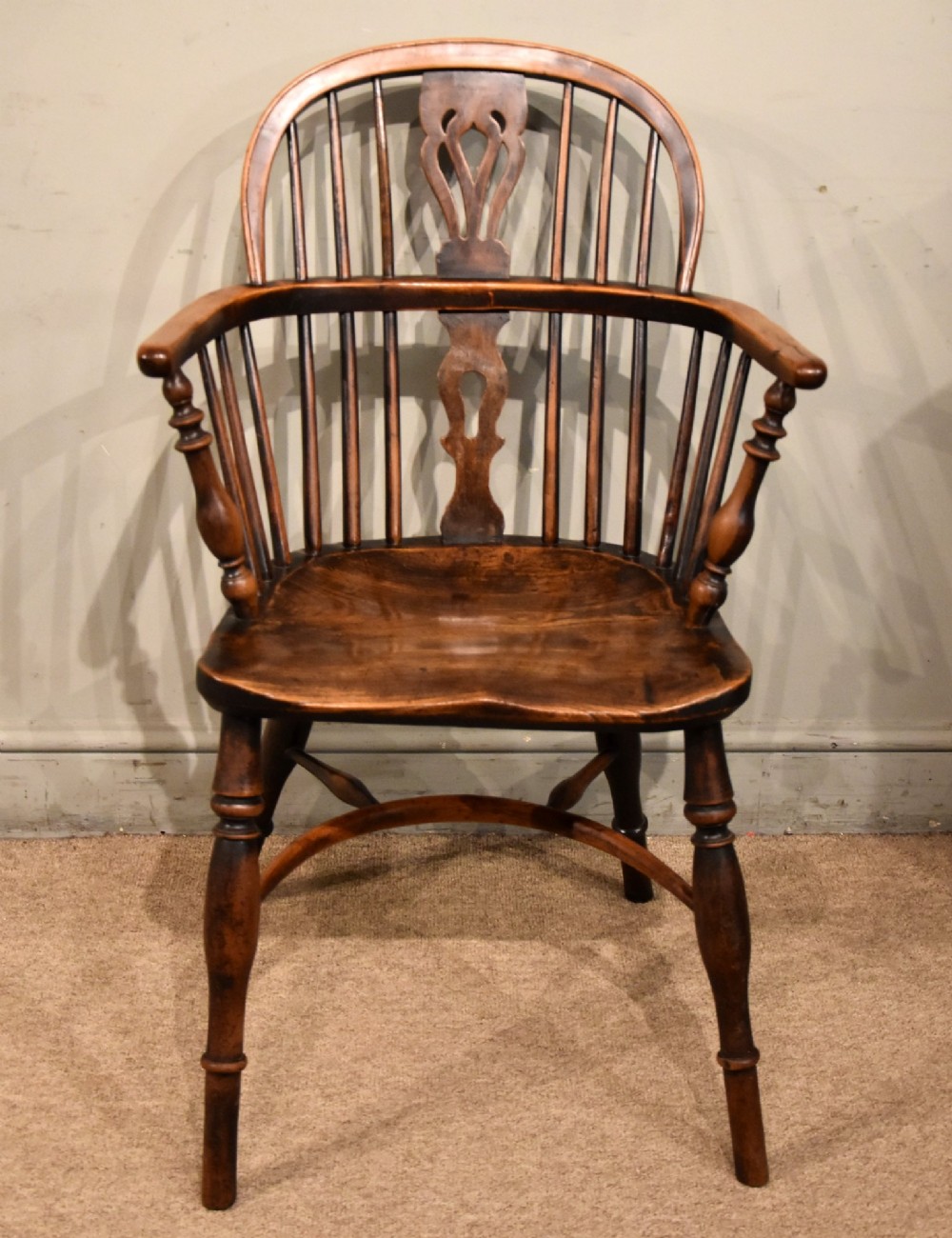 An early 19th-century yew wood Windsor armchair featuring a curved hoop back, pierced splat, turned legs, and a crinoline stretcher. View II
