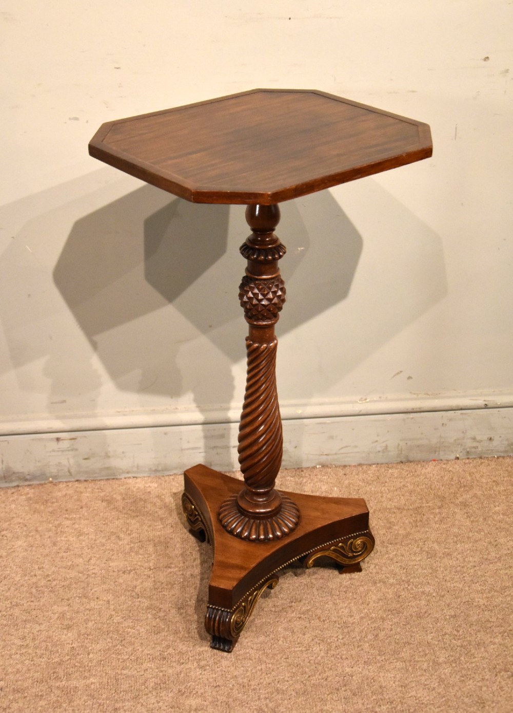 A Regency mahogany occasional table featuring an octagonal top, a carved spiral stem, and a tri-form pedestal base with scroll feet. View II