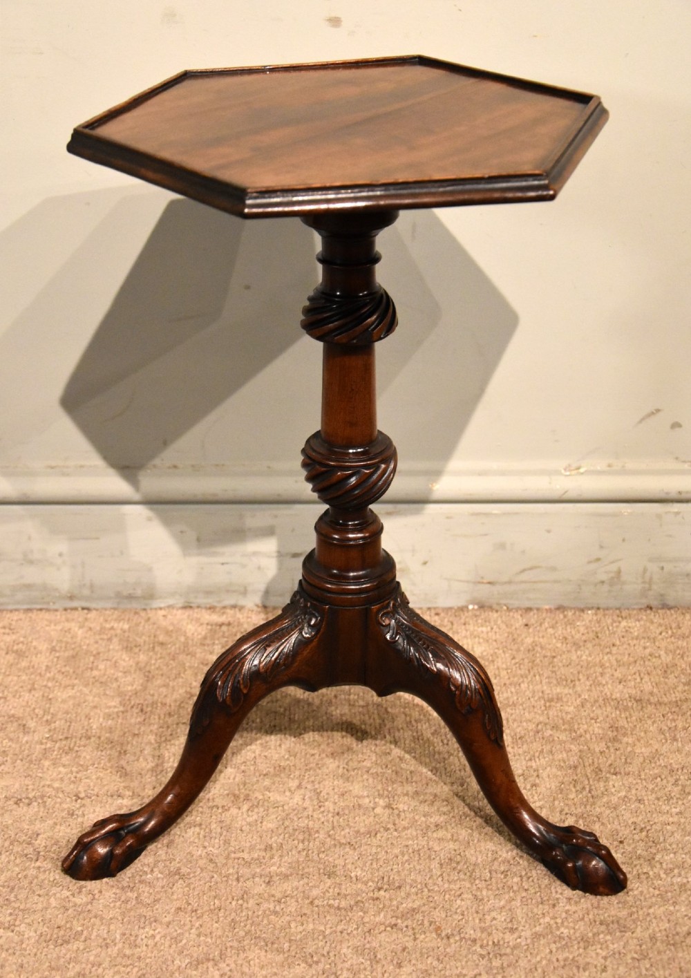An 18th-century carved mahogany kettle stand with a hexagonal top, turned spiral column, and tripod cabriole legs ending in claw-and-ball feet. View II