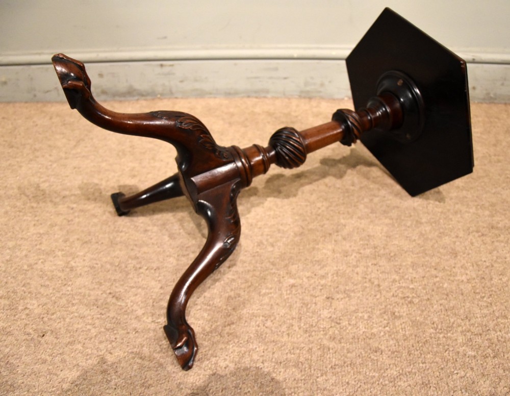 An 18th-century carved mahogany kettle stand with a hexagonal top, turned spiral column, and tripod cabriole legs ending in claw-and-ball feet. View V