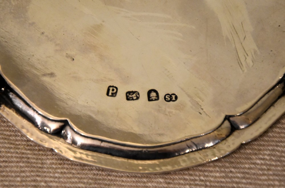 A circular Georgian sterling silver waiter featuring a beaded rim, central engraved monogram, and cast claw-and-ball feet. View IV