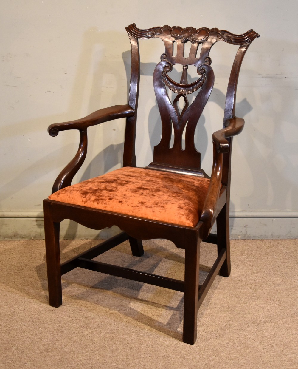 A pair of 18th-century mahogany Irish Chippendale armchairs featuring hand-carved pierced splats, curved arms, and rust-coloured velvet seat pads. View III