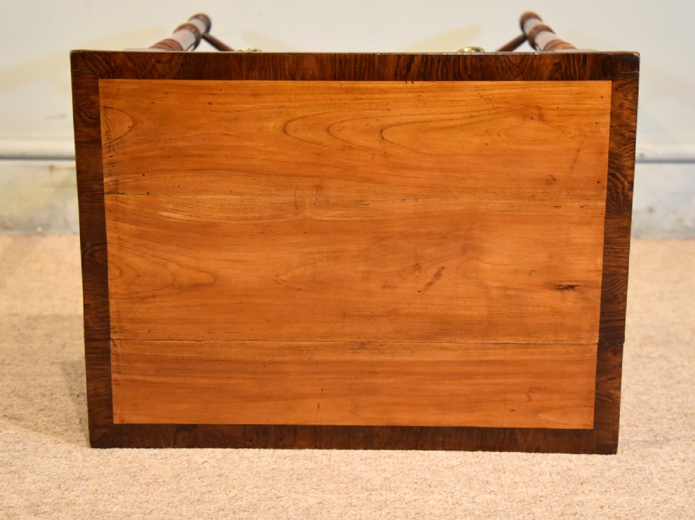 A Regency fruitwood side table featuring two small drawers with round brass knobs, rosewood cross-banding, turned legs, and an X-frame stretcher. View VI