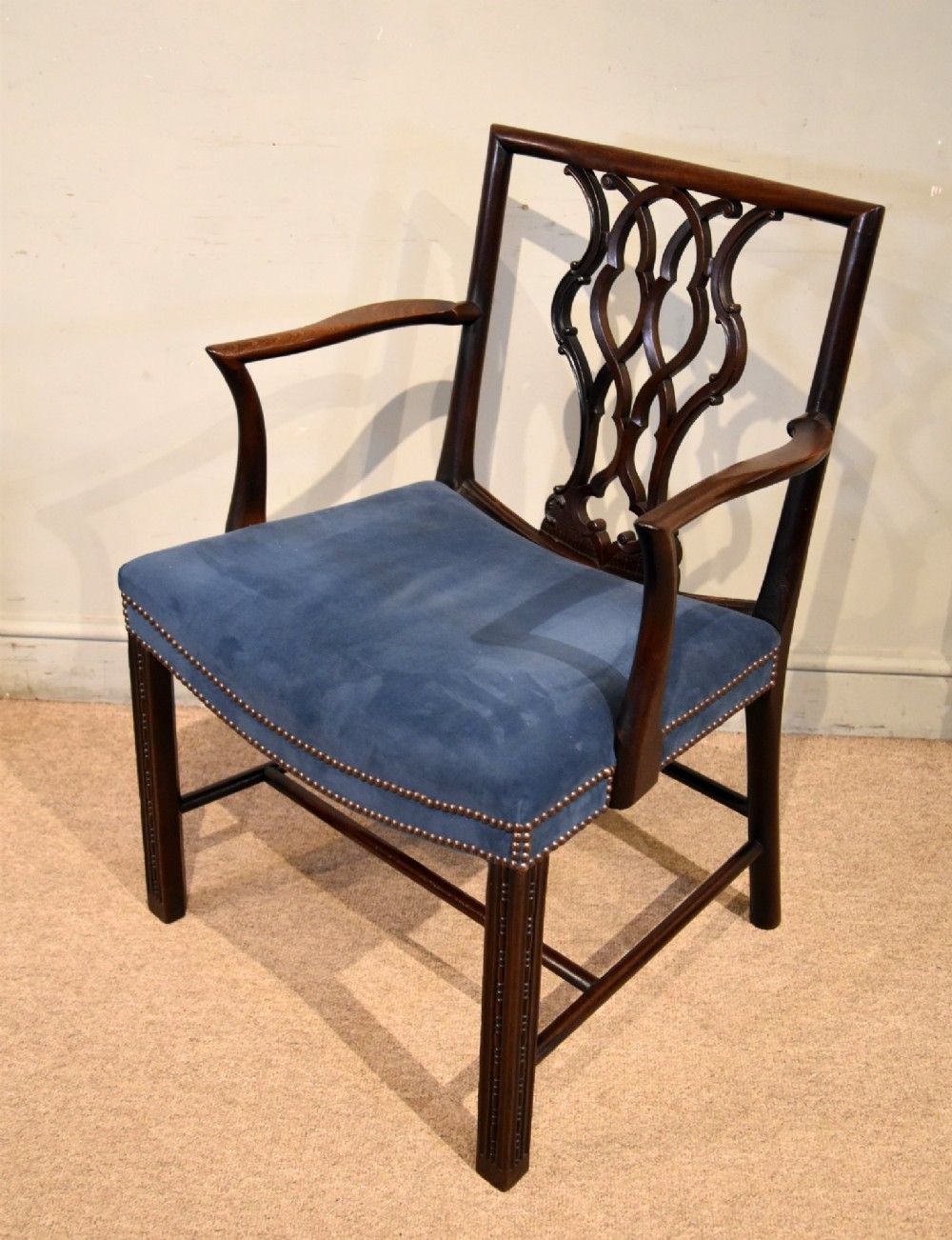 A matched pair of dark mahogany Chippendale style armchairs with intricate pierced back splats and blue velvet upholstered seats with brass stud detailing. View III