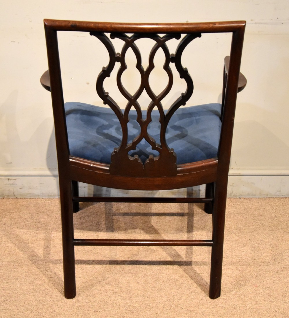 A matched pair of dark mahogany Chippendale style armchairs with intricate pierced back splats and blue velvet upholstered seats with brass stud detailing. View V