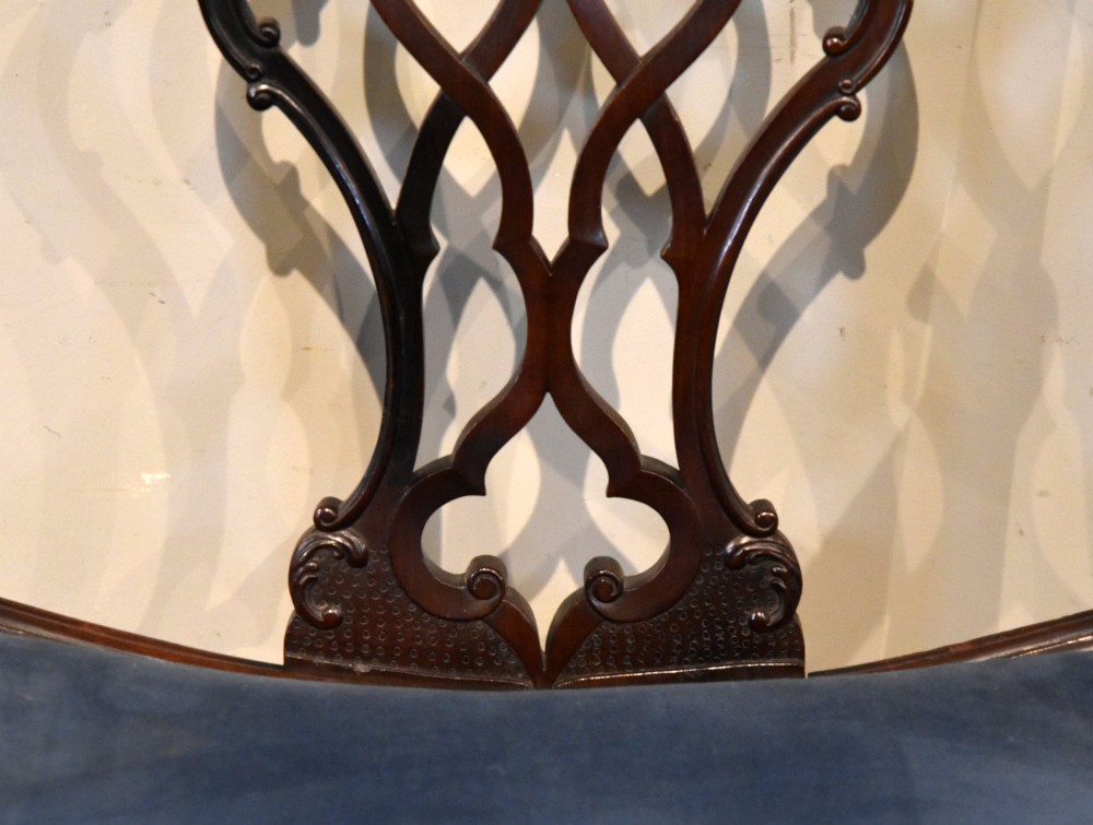 A matched pair of dark mahogany Chippendale style armchairs with intricate pierced back splats and blue velvet upholstered seats with brass stud detailing. View VII