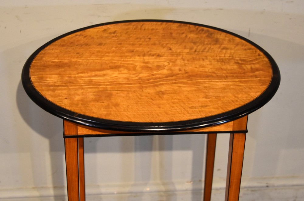 A late 18th-century oval satinwood occasional table featuring a dark banded top border and slender square tapered legs. View II