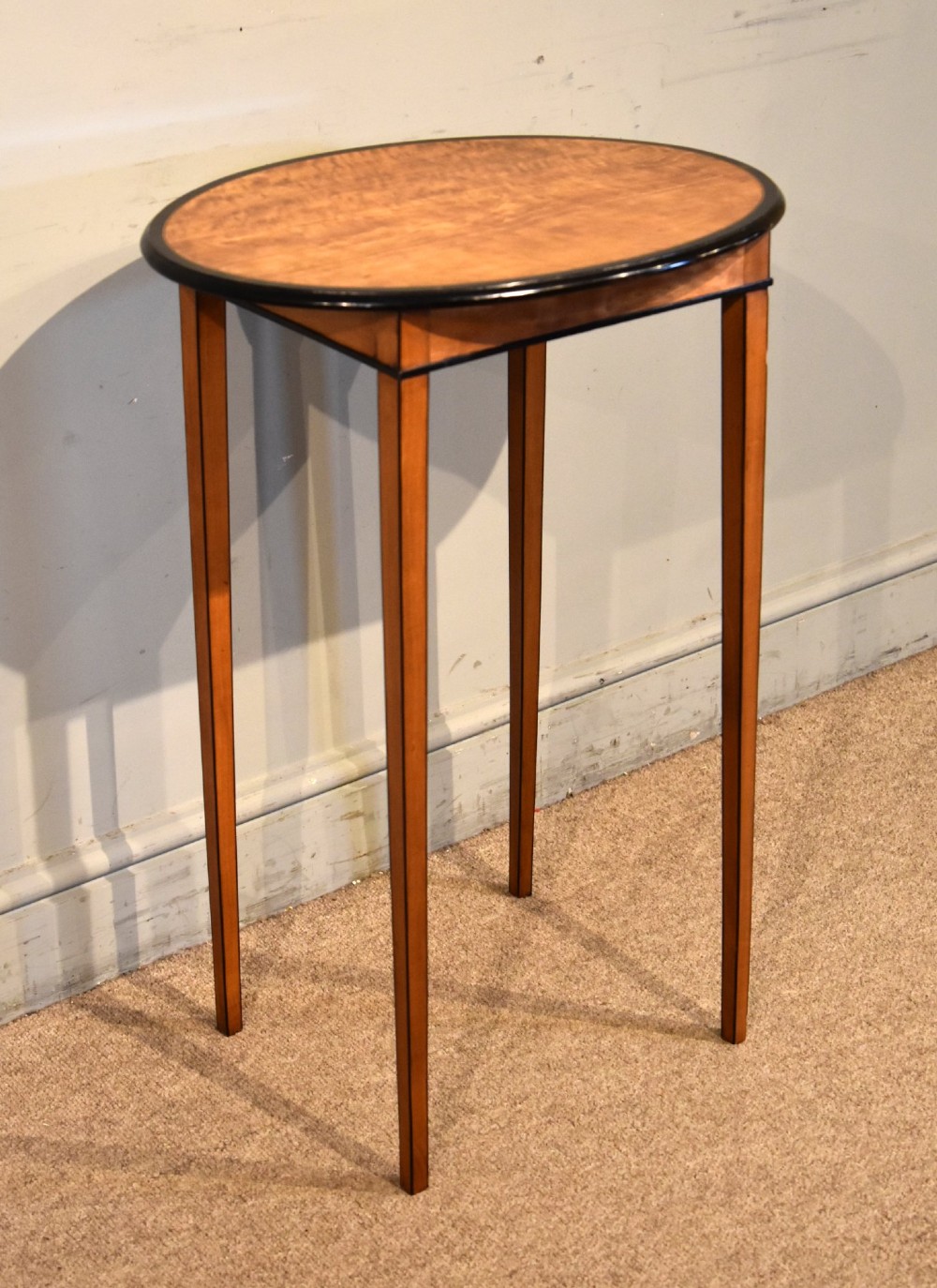 A late 18th-century oval satinwood occasional table featuring a dark banded top border and slender square tapered legs. View III