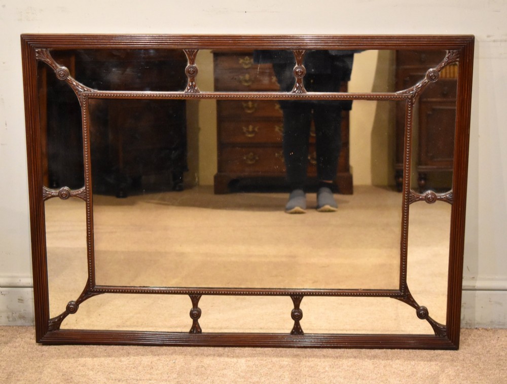 A large rectangular 19th-century mahogany wall mirror featuring a reeded outer frame and decorative carved rosettes on internal sectioning lines. View IV