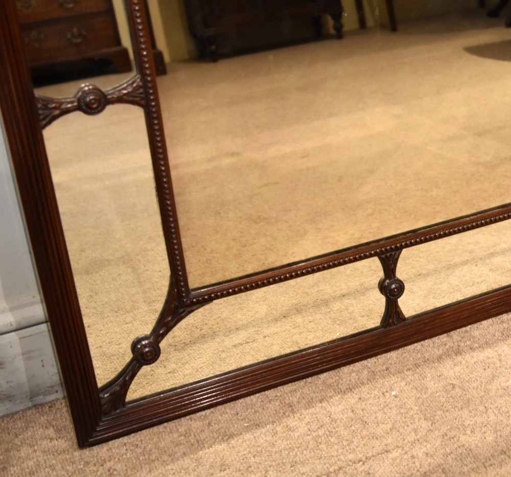 A large rectangular 19th-century mahogany wall mirror featuring a reeded outer frame and decorative carved rosettes on internal sectioning lines. View V