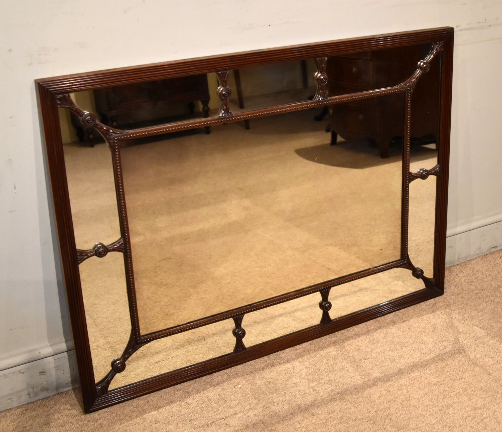 A large rectangular 19th-century mahogany wall mirror featuring a reeded outer frame and decorative carved rosettes on internal sectioning lines. View VI