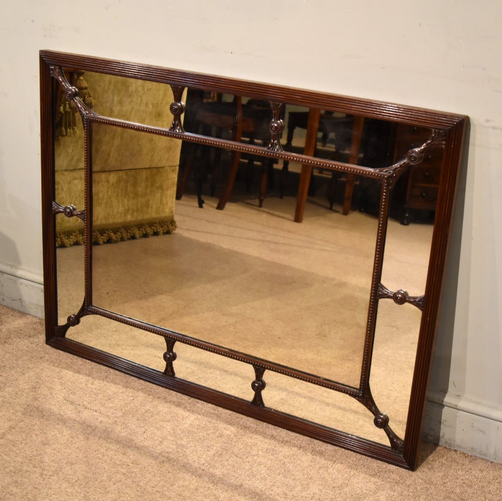 A large rectangular 19th-century mahogany wall mirror featuring a reeded outer frame and decorative carved rosettes on internal sectioning lines. View VII
