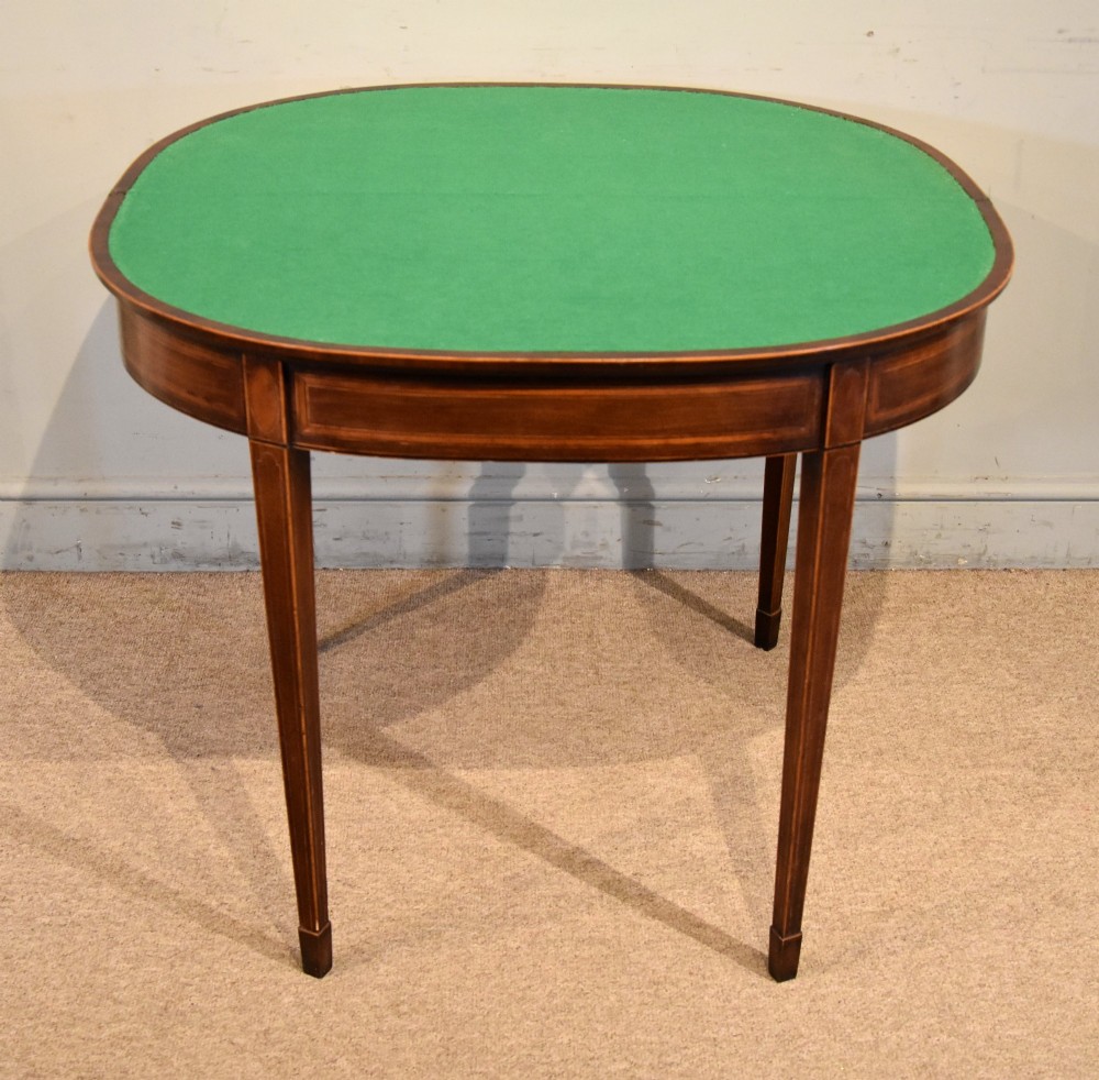 A George III mahogany demi-lune card table featuring boxwood stringing inlay and square tapered legs. View V