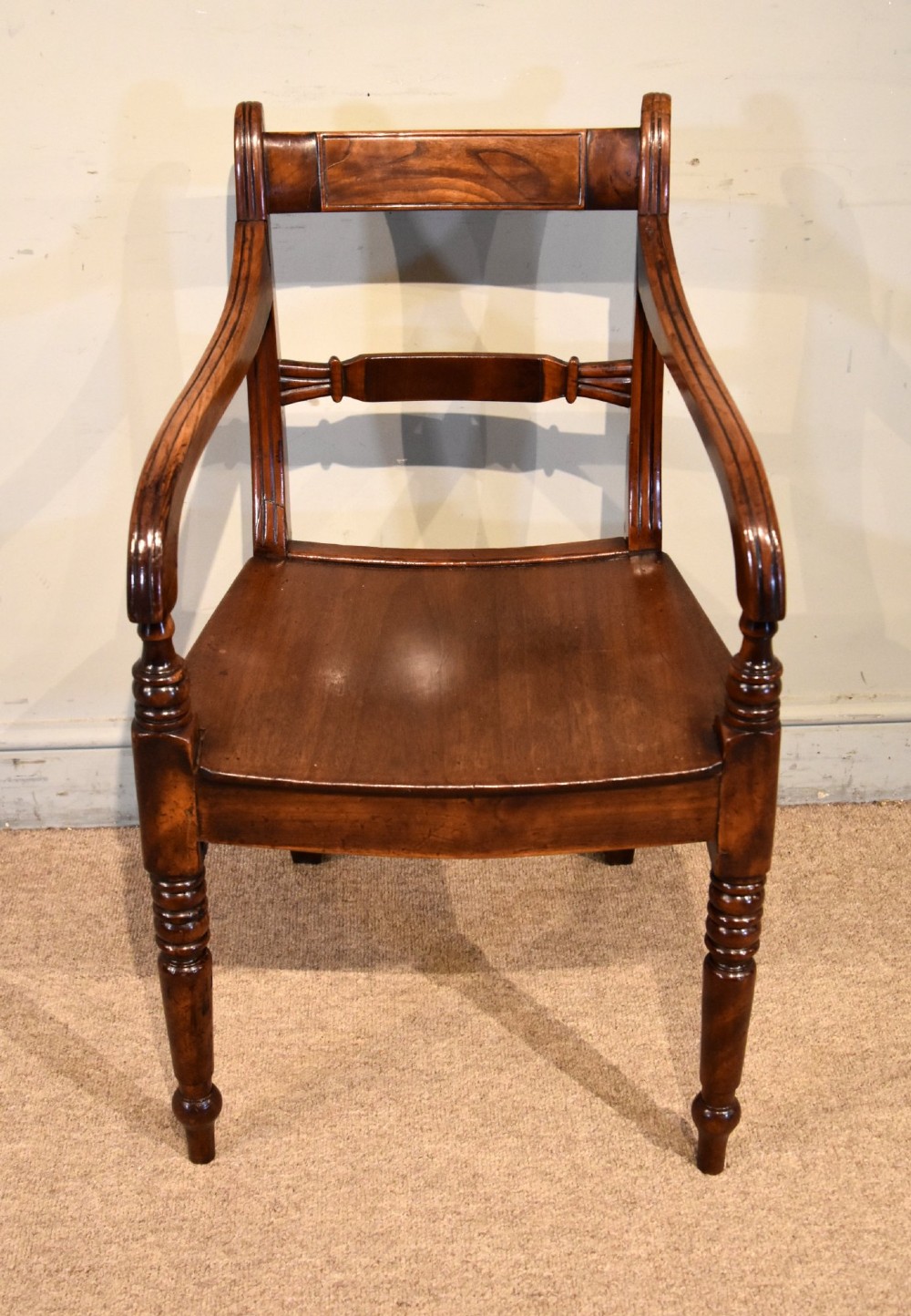 A set of six 19th-century warm brown fruitwood dining chairs comprising two carvers and four side chairs with bar backs and turned front legs. View III