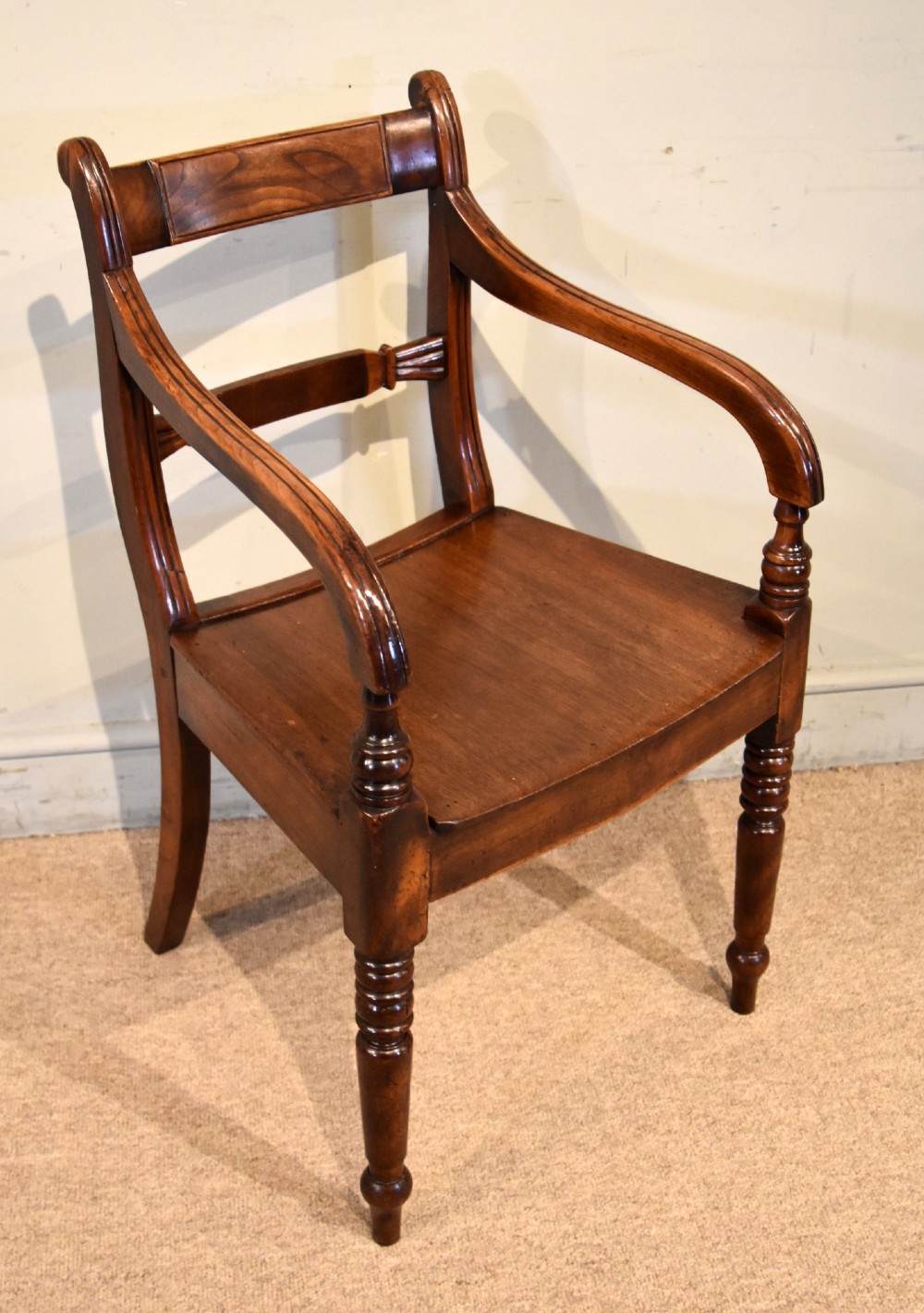 A set of six 19th-century warm brown fruitwood dining chairs comprising two carvers and four side chairs with bar backs and turned front legs. View IV