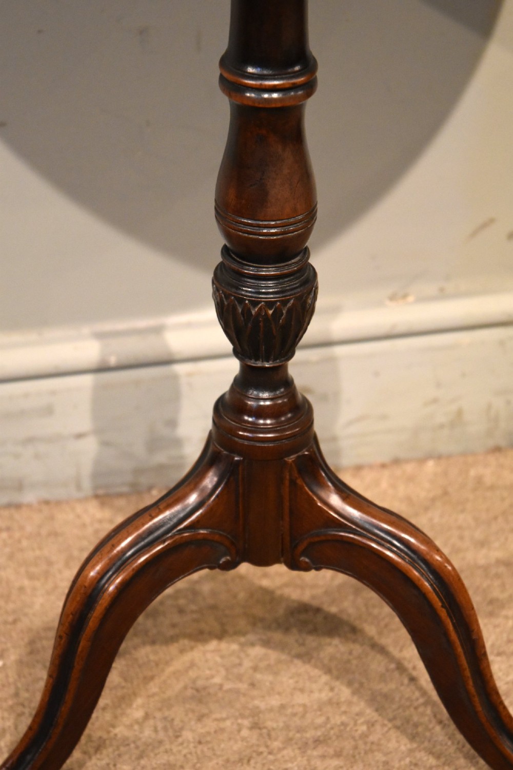 An 18th-century Hepplewhite mahogany wine table featuring a circular dish top, turned central pedestal, and tripod legs. View V