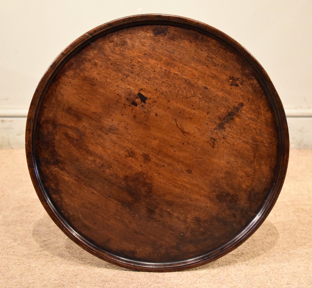 An 18th-century Hepplewhite mahogany wine table featuring a circular dish top, turned central pedestal, and tripod legs. View VI