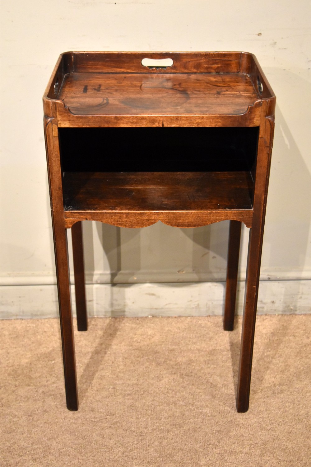 A George III mahogany pot cupboard featuring a gallery tray top with cut-out handles, an open storage shelf, and square straight legs. View II