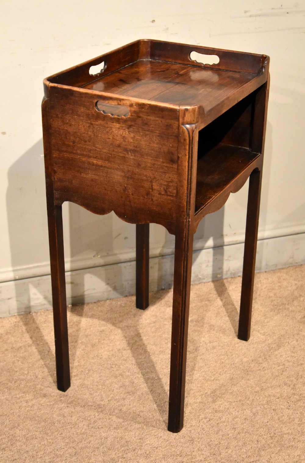 A George III mahogany pot cupboard featuring a gallery tray top with cut-out handles, an open storage shelf, and square straight legs. View IV