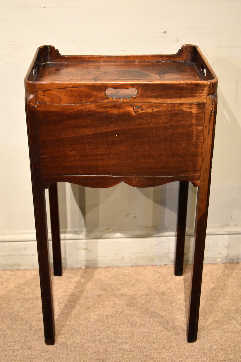 A George III mahogany pot cupboard featuring a gallery tray top with cut-out handles, an open storage shelf, and square straight legs. View V