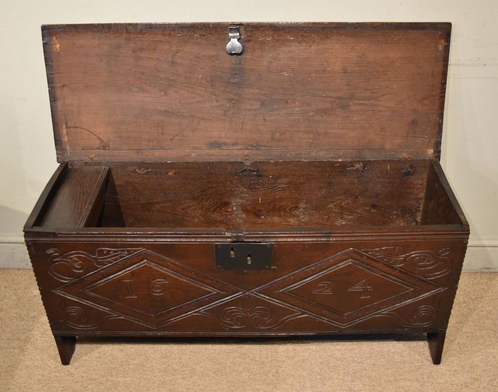 A 17th-century dark oak six-plank coffer featuring carved lozenge patterns containing the date 1624 and a central iron lockplate. View II