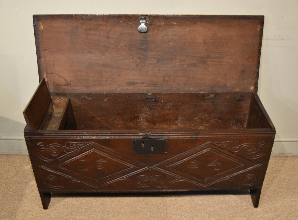 A 17th-century dark oak six-plank coffer featuring carved lozenge patterns containing the date 1624 and a central iron lockplate. View III