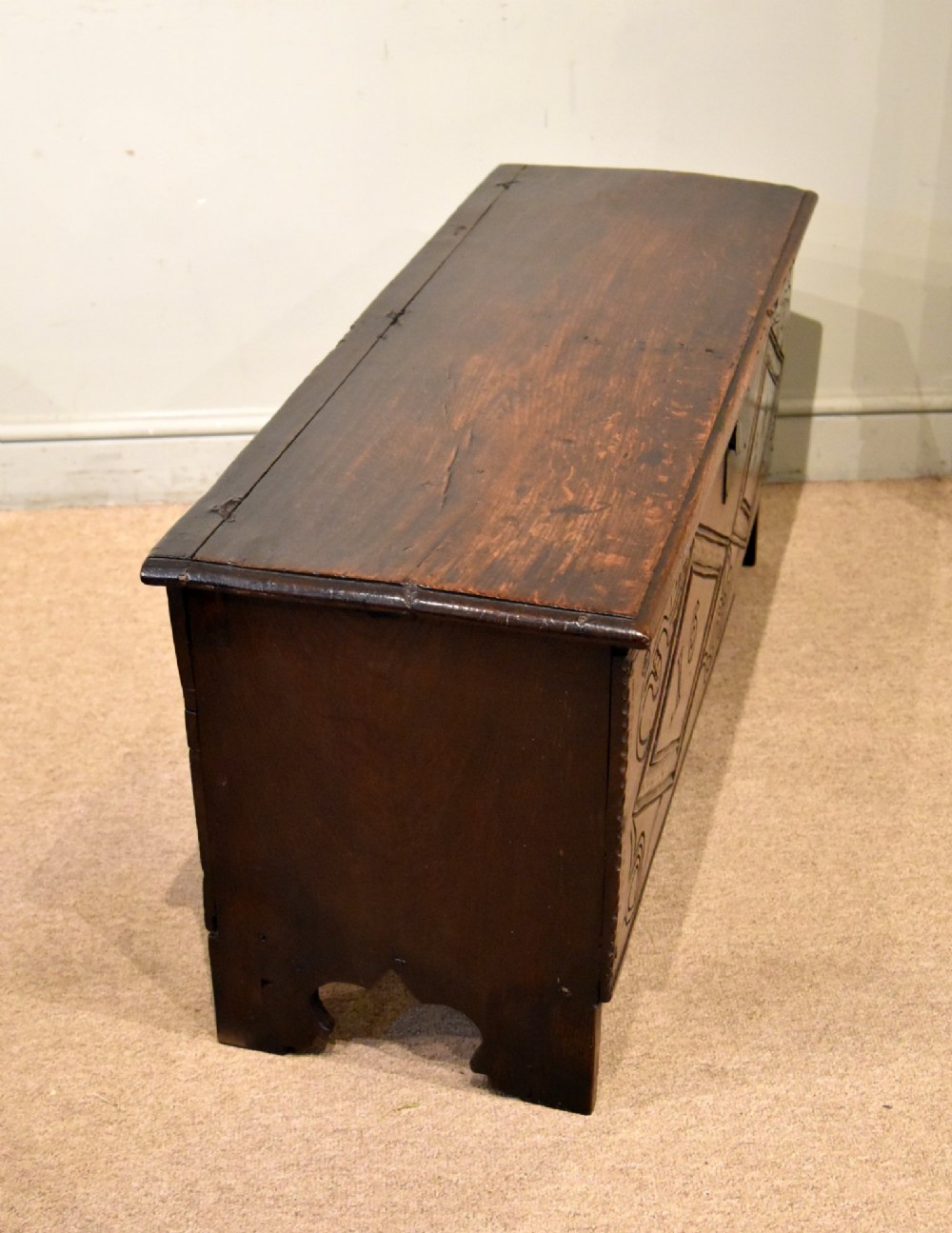 A 17th-century dark oak six-plank coffer featuring carved lozenge patterns containing the date 1624 and a central iron lockplate. View VIII