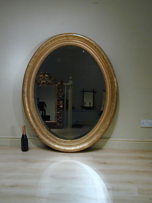 an impressively large oval wall mirror - CATEGORY: ANTIQUE MIRRORS - DATED 1890