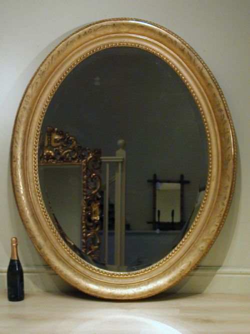 AN IMPRESSIVELY LARGE OVAL WALL MIRROR - ADDITIONAL PHOTO 1