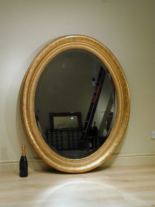 AN IMPRESSIVELY LARGE OVAL WALL MIRROR - ADDITIONAL PHOTO 2