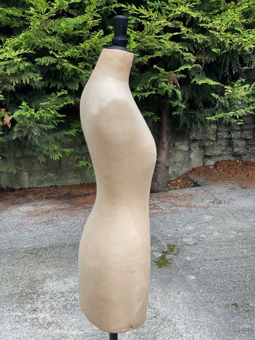 A fabric-covered female tailors dummy torso featuring stitched neutral linen upholstery and a dark turned neck finial. View VI