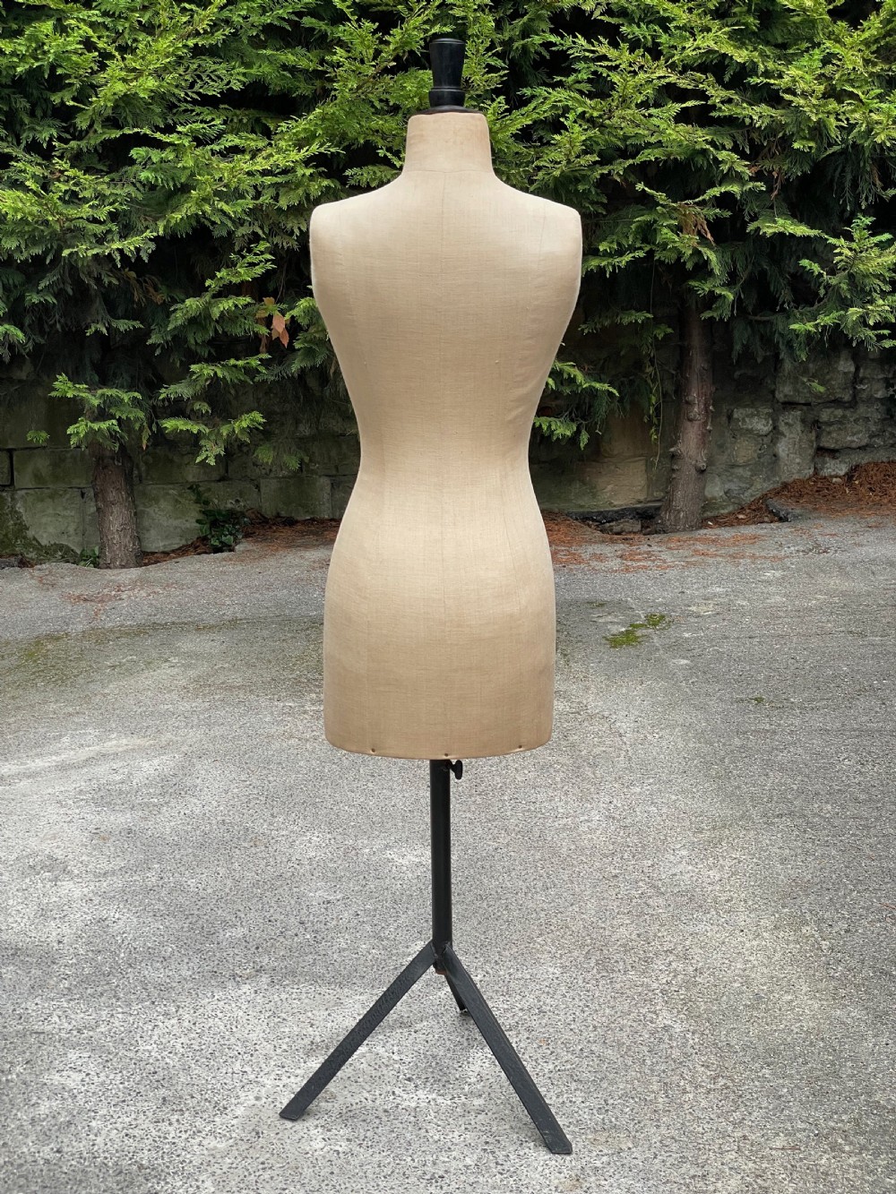 A fabric-covered female tailors dummy torso featuring stitched neutral linen upholstery and a dark turned neck finial. View XII