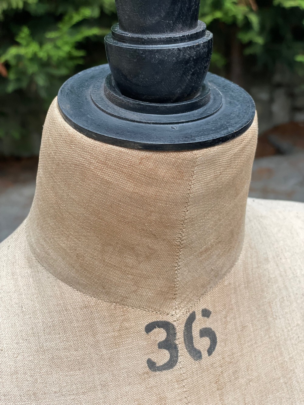 A fabric-covered female tailors dummy torso featuring stitched neutral linen upholstery and a dark turned neck finial. View XIV