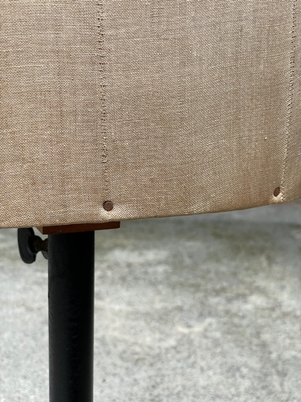 A fabric-covered female tailors dummy torso featuring stitched neutral linen upholstery and a dark turned neck finial. View XVI
