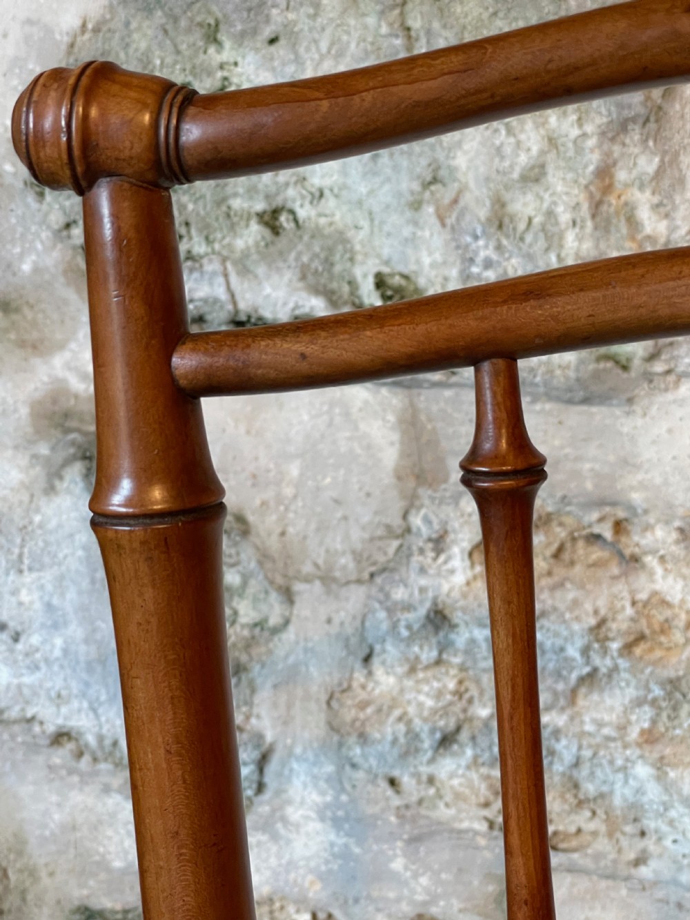 An antique Victorian faux bamboo turned wood childs high chair featuring a woven cane seat and integrated footrest. View IX