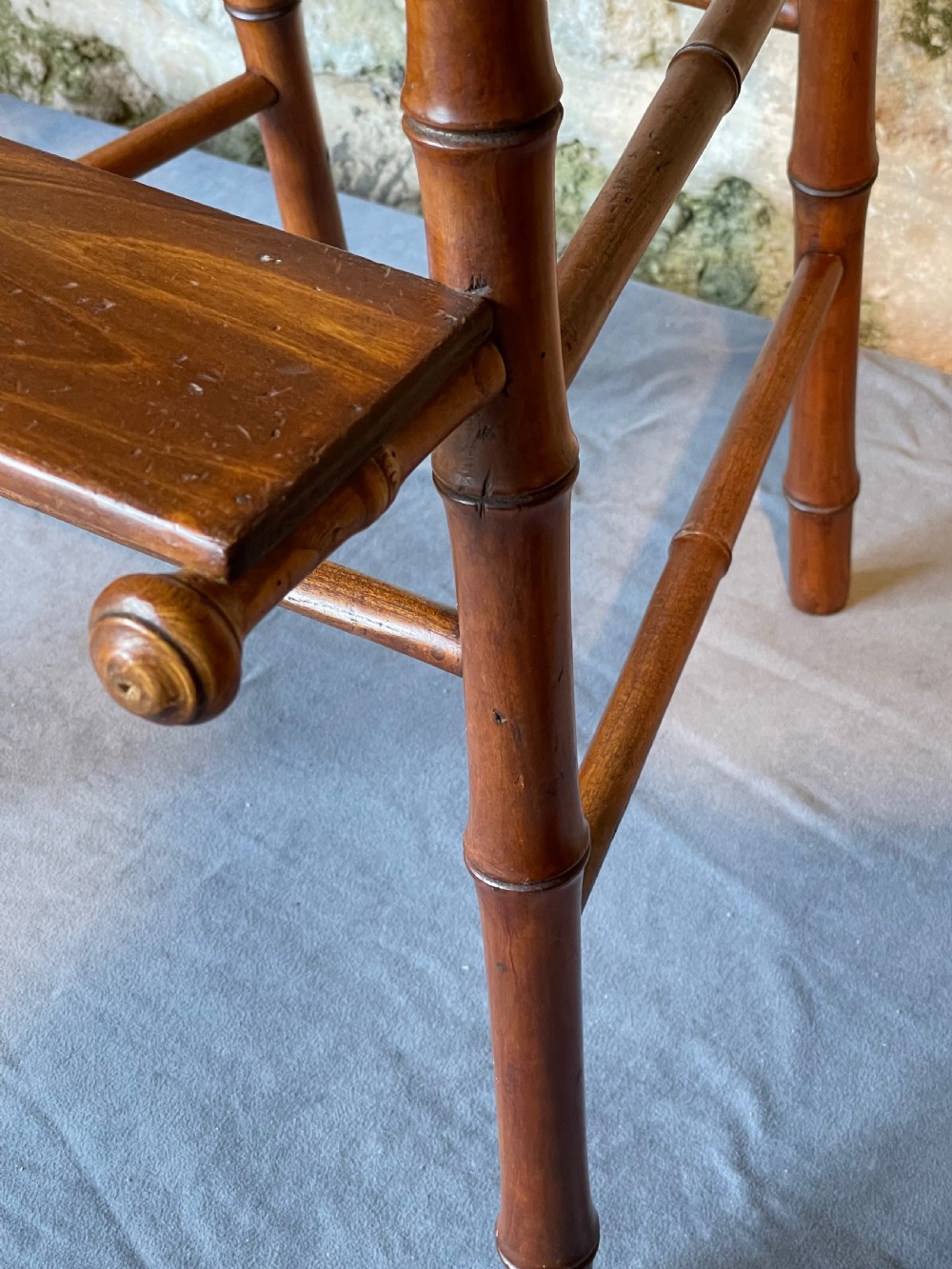 An antique Victorian faux bamboo turned wood childs high chair featuring a woven cane seat and integrated footrest. View XI