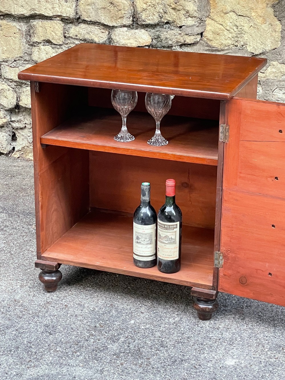 A Victorian warm brown wooden chest featuring four horizontal drawers with matching wooden knob handles and turned feet. View X