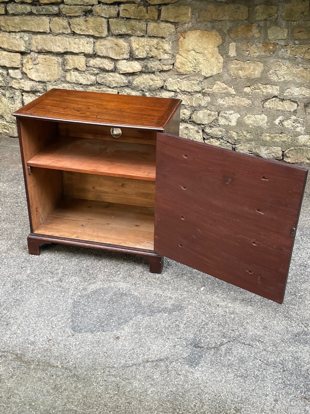 A Georgian mahogany chest featuring four drawer fronts with turned wooden handles and bracket feet. View VIII