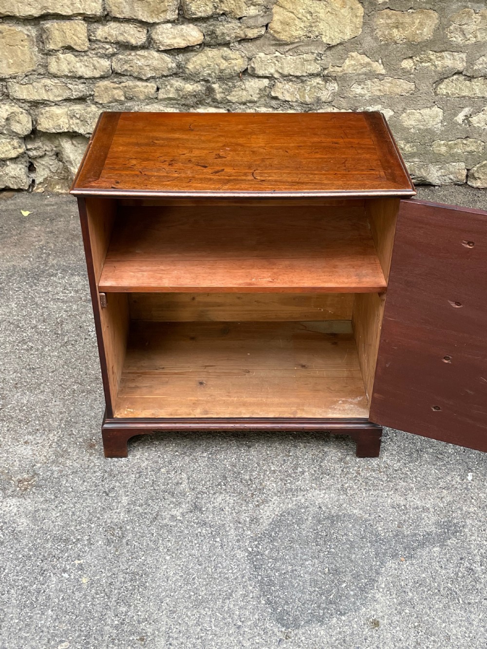 A Georgian mahogany chest featuring four drawer fronts with turned wooden handles and bracket feet. View IX