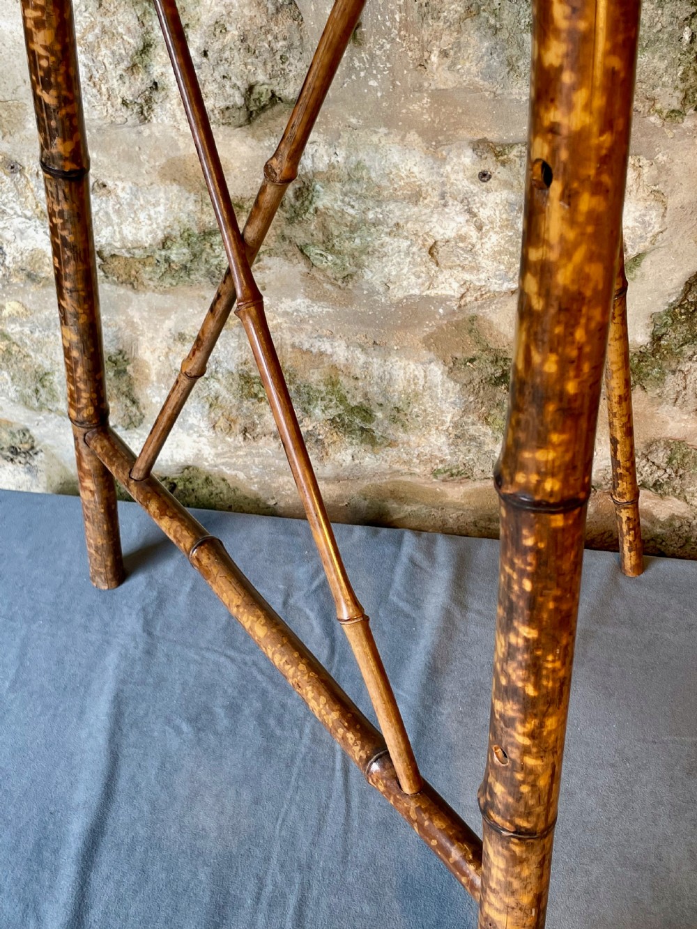 A tall Victorian freestanding easel crafted from mottled brown bamboo with cross-bracing and support pegs. View VI