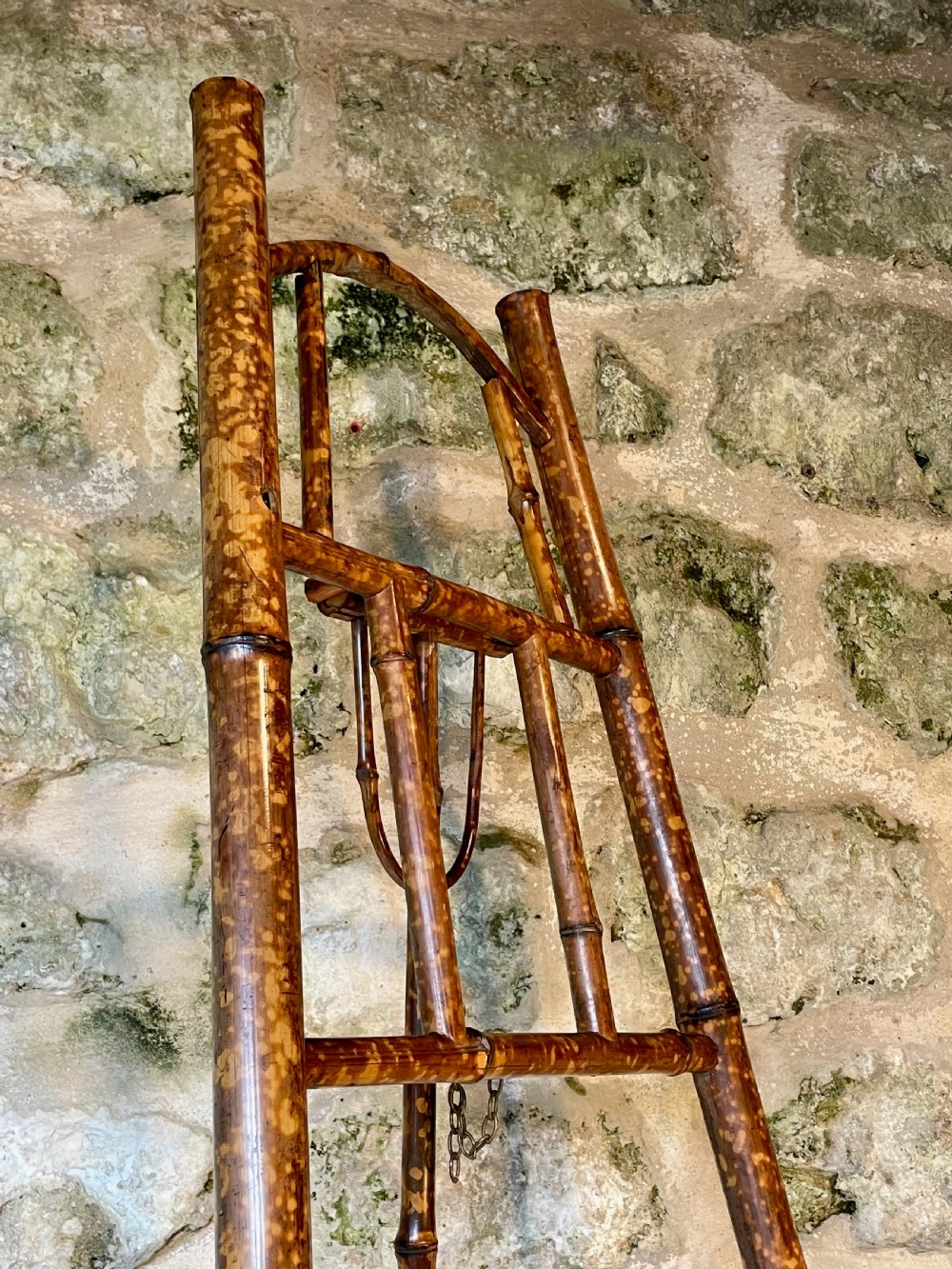 A tall Victorian freestanding easel crafted from mottled brown bamboo with cross-bracing and support pegs. View VII