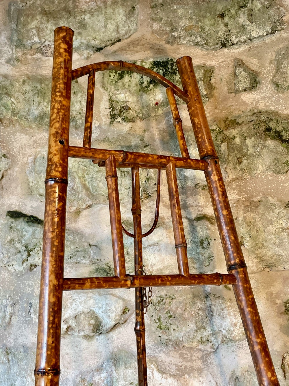A tall Victorian freestanding easel crafted from mottled brown bamboo with cross-bracing and support pegs. View VIII