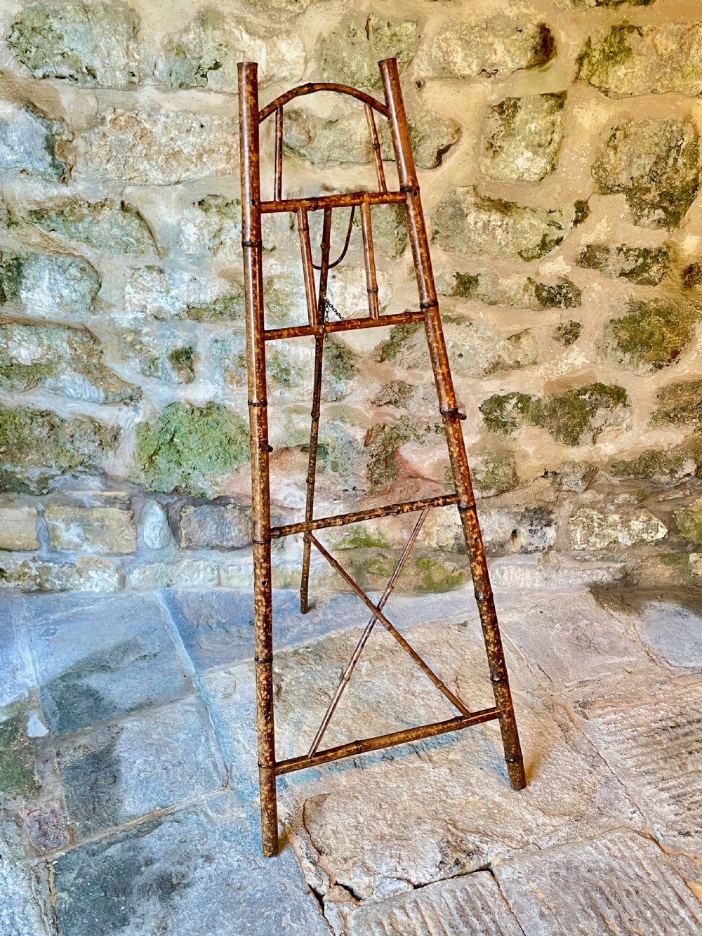 A tall Victorian freestanding easel crafted from mottled brown bamboo with cross-bracing and support pegs. View XII