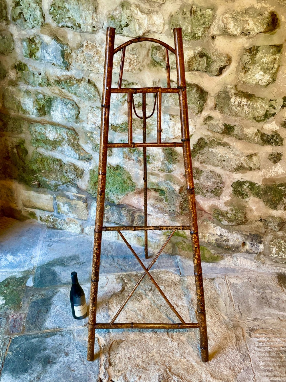 A tall Victorian freestanding easel crafted from mottled brown bamboo with cross-bracing and support pegs. View XVI