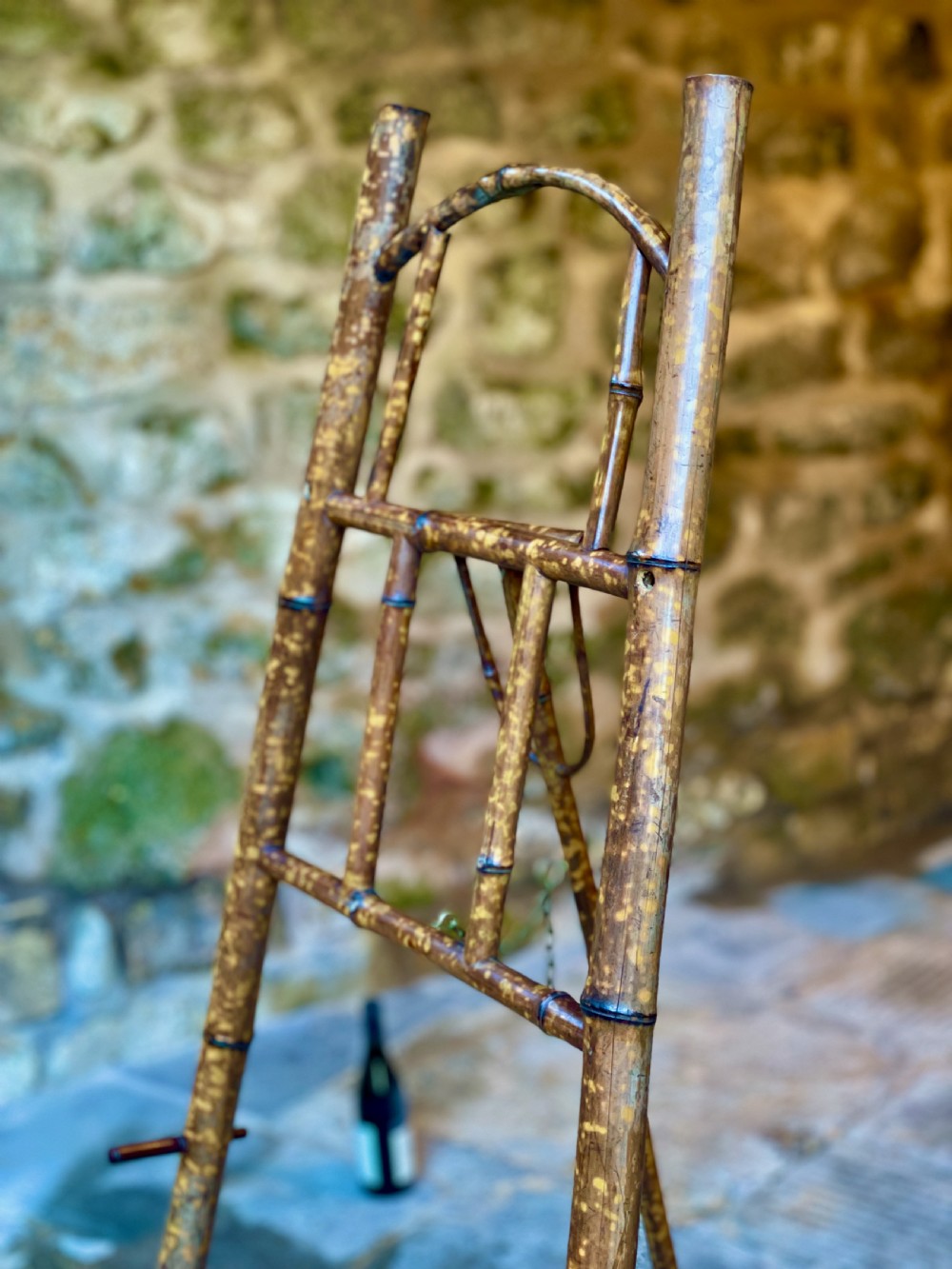 A tall Victorian freestanding easel crafted from mottled brown bamboo with cross-bracing and support pegs. View XVIII