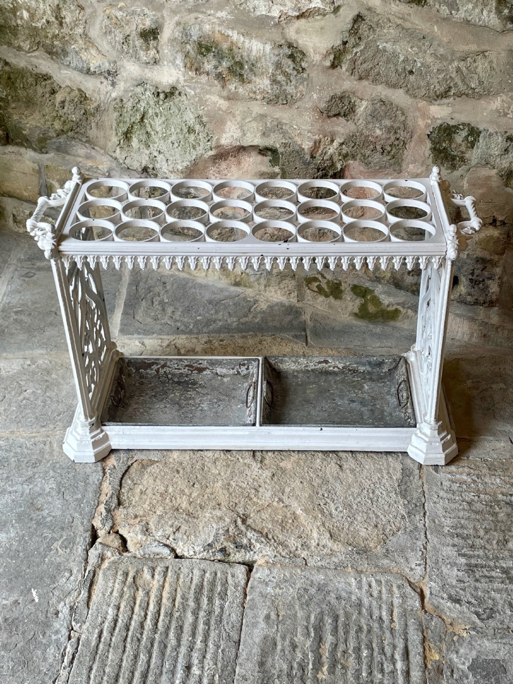 A white painted cast iron stick stand featuring openwork Gothic tracery side panels, a circular grid top section, and a removable double drip tray. View IV