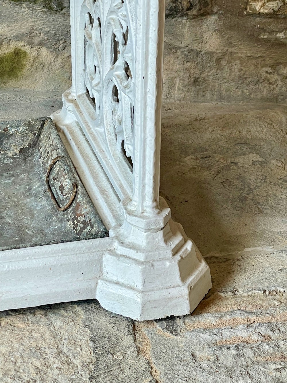 A white painted cast iron stick stand featuring openwork Gothic tracery side panels, a circular grid top section, and a removable double drip tray. View VI