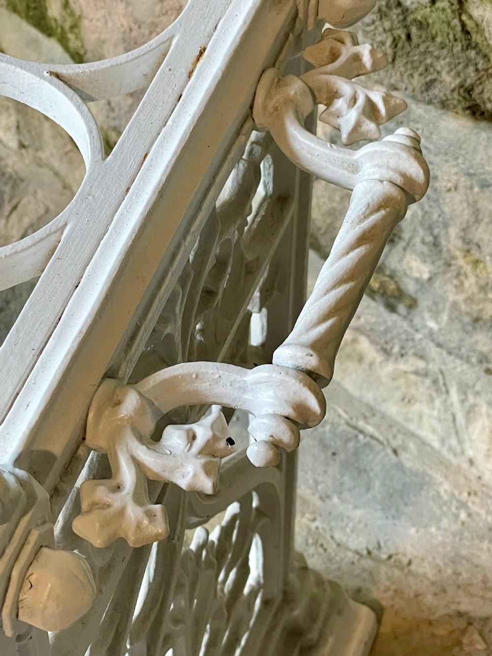 A white painted cast iron stick stand featuring openwork Gothic tracery side panels, a circular grid top section, and a removable double drip tray. View VII
