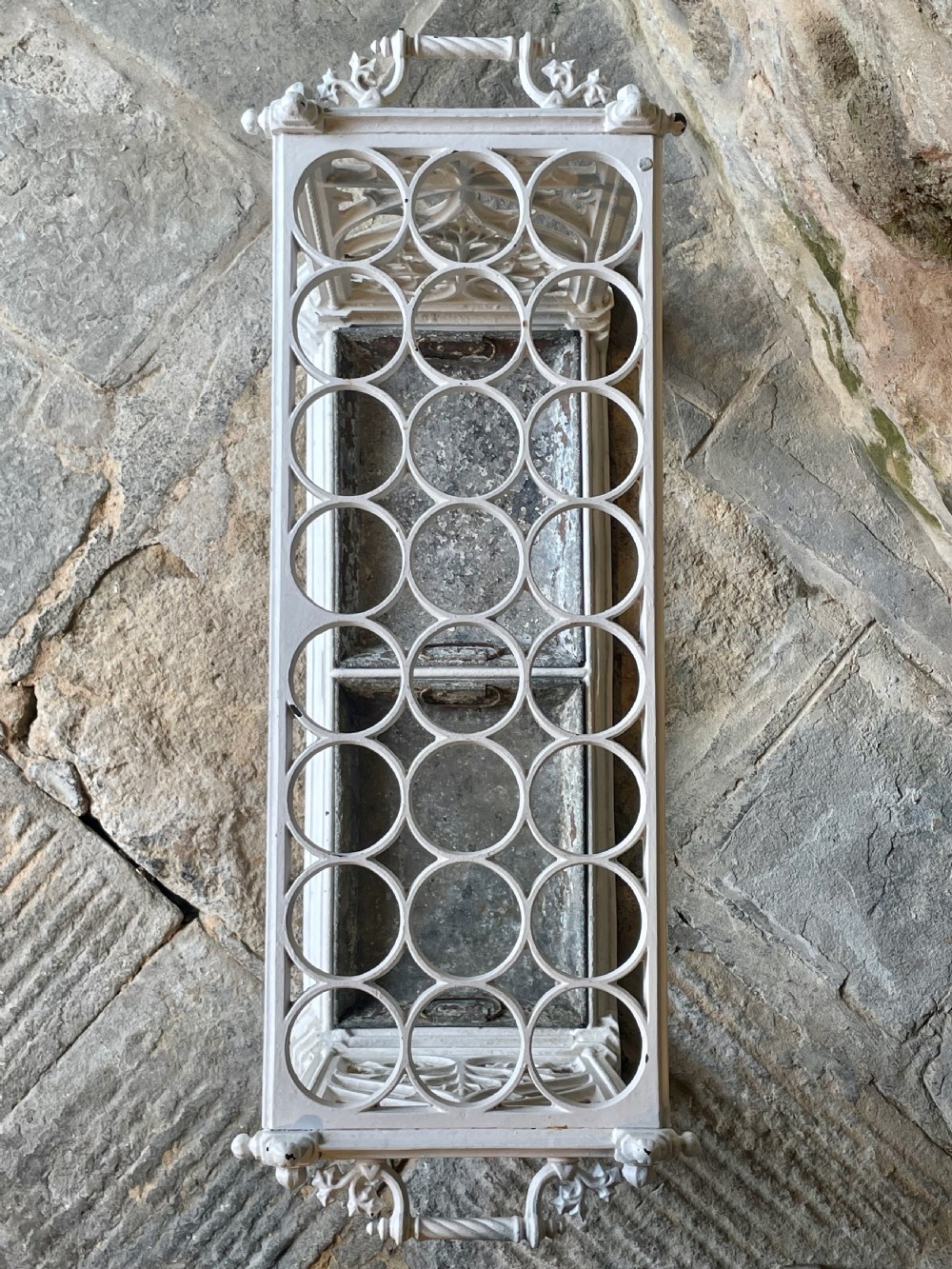 A white painted cast iron stick stand featuring openwork Gothic tracery side panels, a circular grid top section, and a removable double drip tray. View XVI