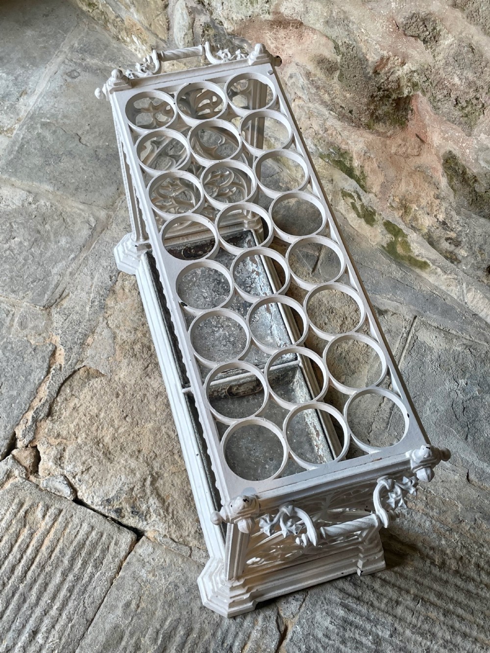 A white painted cast iron stick stand featuring openwork Gothic tracery side panels, a circular grid top section, and a removable double drip tray. View XVII